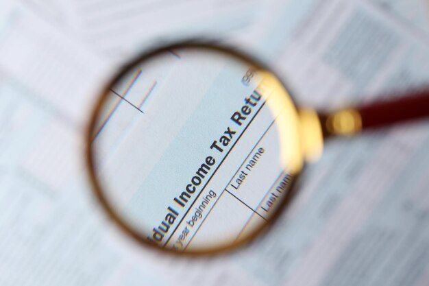 A detailed close-up of a U.S. tax form highlighting sections related to investment income, capital gains, and deductions, with a magnifying glass focusing on the highlighted areas.