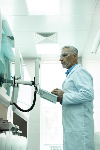 A modern, technologically advanced healthcare facility showcasing robotic arms assisting in surgery, highlighting the integration of technology in elderly care.