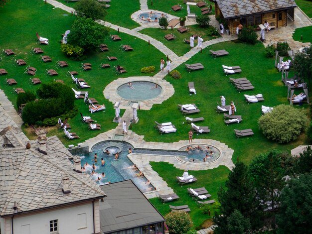 An aerial view of a sprawling, resort-style retirement community, complete with swimming pools, golf courses, and walking trails, emphasizing active and luxurious senior living.