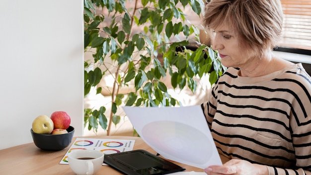 A person looking at a balanced graph indicating good personal savings while sitting relaxed in home environment.