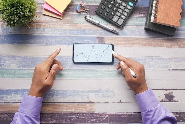 A person using a mobile app on their smartphone with a clear and intuitive interface displaying various financial planning tools such as budgeting, investment tracking, and debt management, set against a backdrop of diverse financial scenarios represented by icons.