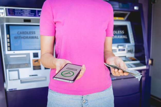 A close-up shot of a person depositing cash into a savings account at a bank, with the teller machine displaying the updated balance. The atmosphere is professional and trustworthy.