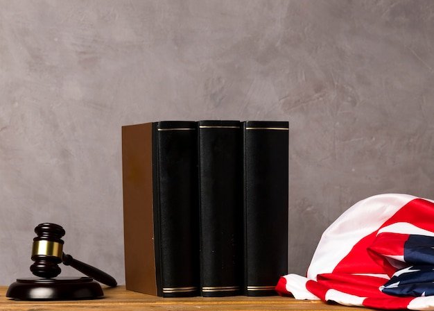 A close-up shot of a gavel resting on a stack of law books, with a blurred background showing the US Capitol building. This image symbolizes the intersection of law and cryptocurrency.