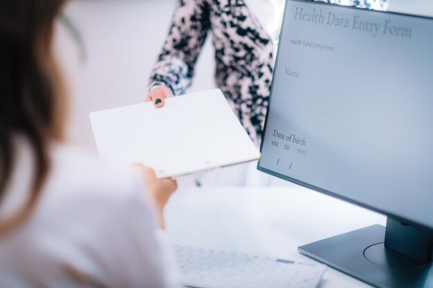 A person on a computer filing an official report on the FTC website, with a close-up on the reporting form.