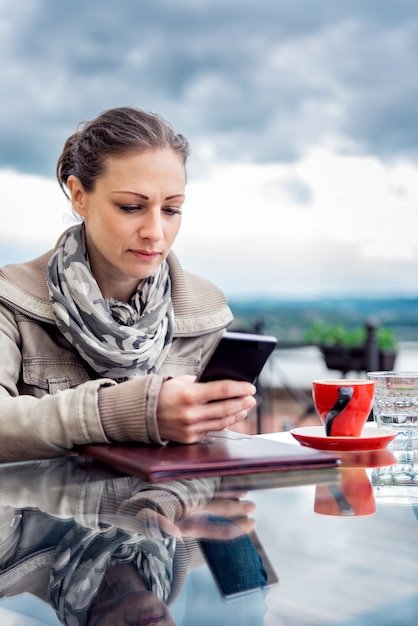 A person using a budgeting app on their smartphone to track travel expenses, emphasizing the importance of financial management during a trip.