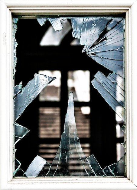 A split image showing a regular window shattered on one side and an impact-resistant window intact on the other, both after being hit by debris.