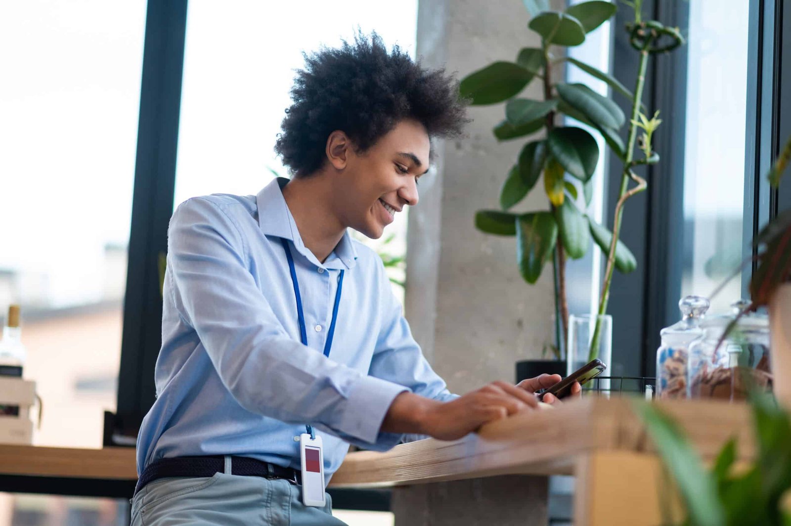A person working on a laptop with a happy expression, surrounded by icons representing various side hustles like freelancing, online courses, and e-commerce. The background shows a modern, organized home office.