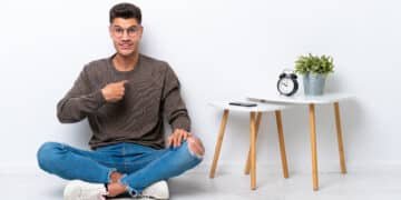 Young caucasian man sitting in his home isolated on white background with surprise facial expression
