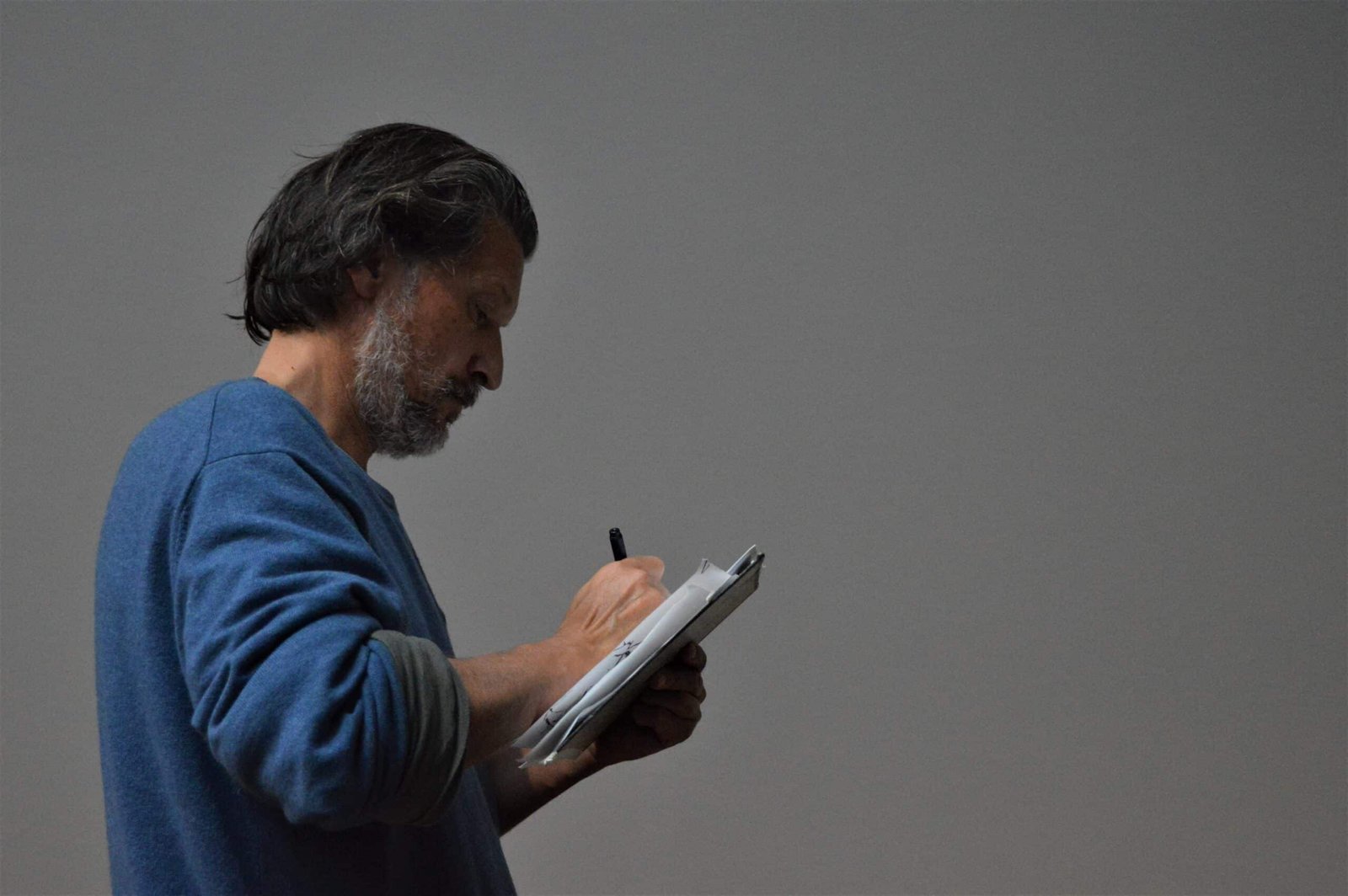 A person reviewing a credit report on a tablet, with a magnifying glass highlighting a specific section, symbolizing the importance of careful monitoring.